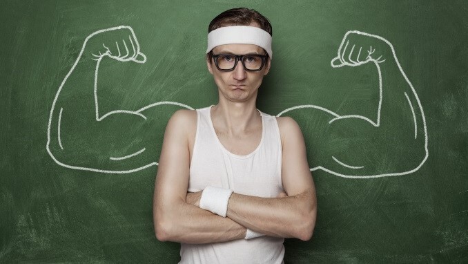 Funny sport nerd with fake muscle drawn on the chalkboard