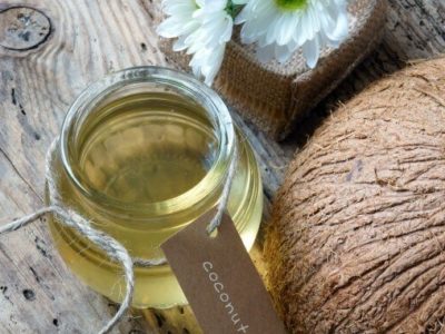 Coconut oil, essential oil from nature, a skin care that safe, rich vintamin, use in massage at spa, organic cosmetic on wooden background